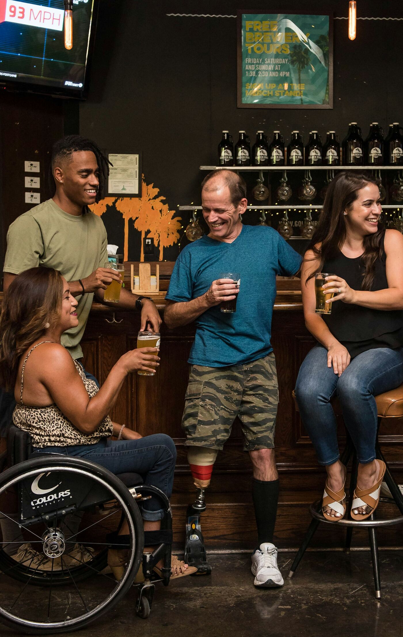 Friends socializing together, including wheelchair and prosthetic leg users