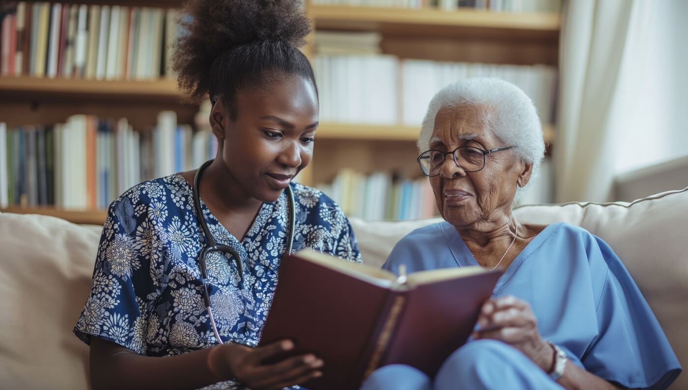 Caregiver reading with an elderly woman