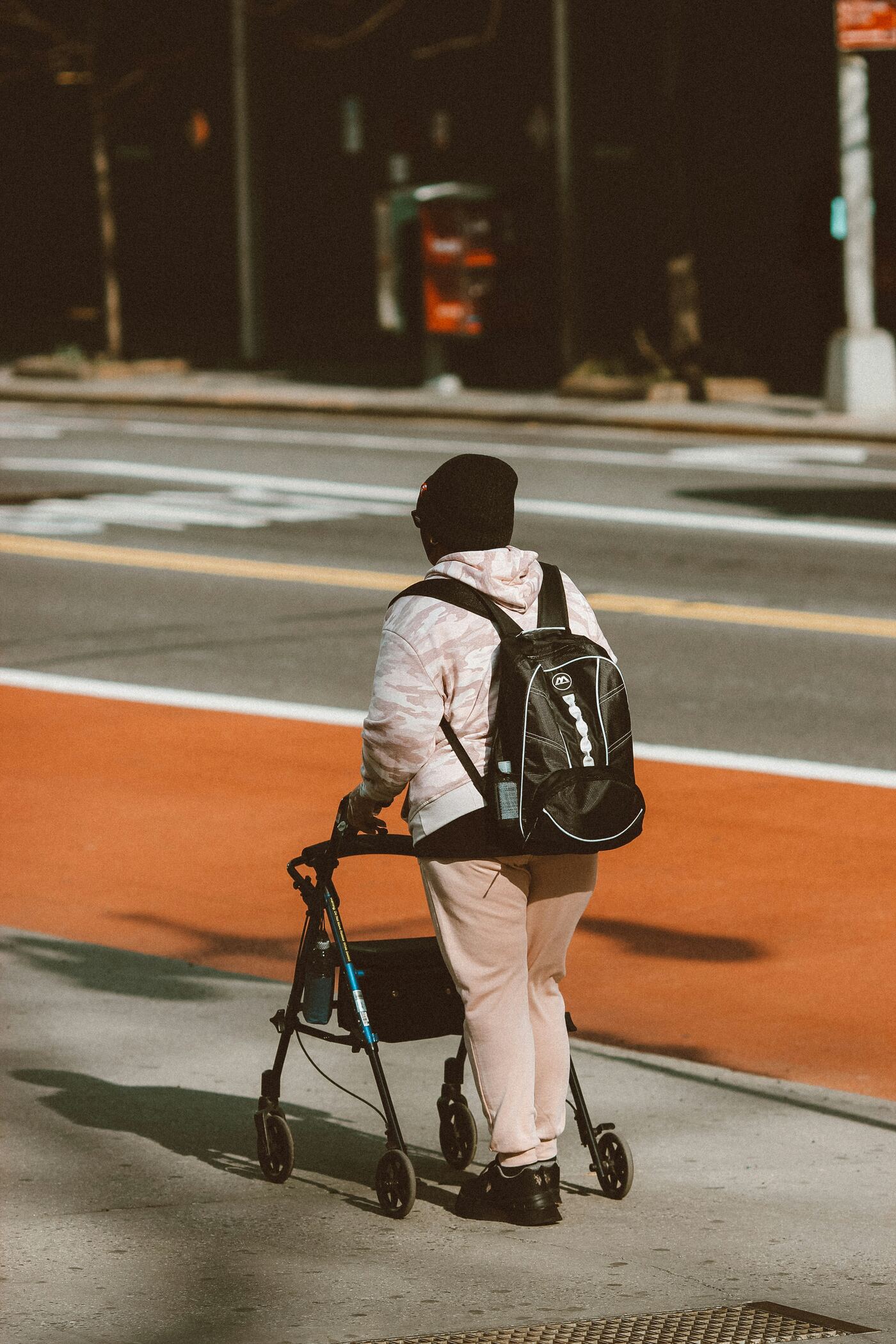 Person using a mobility walker on a city street